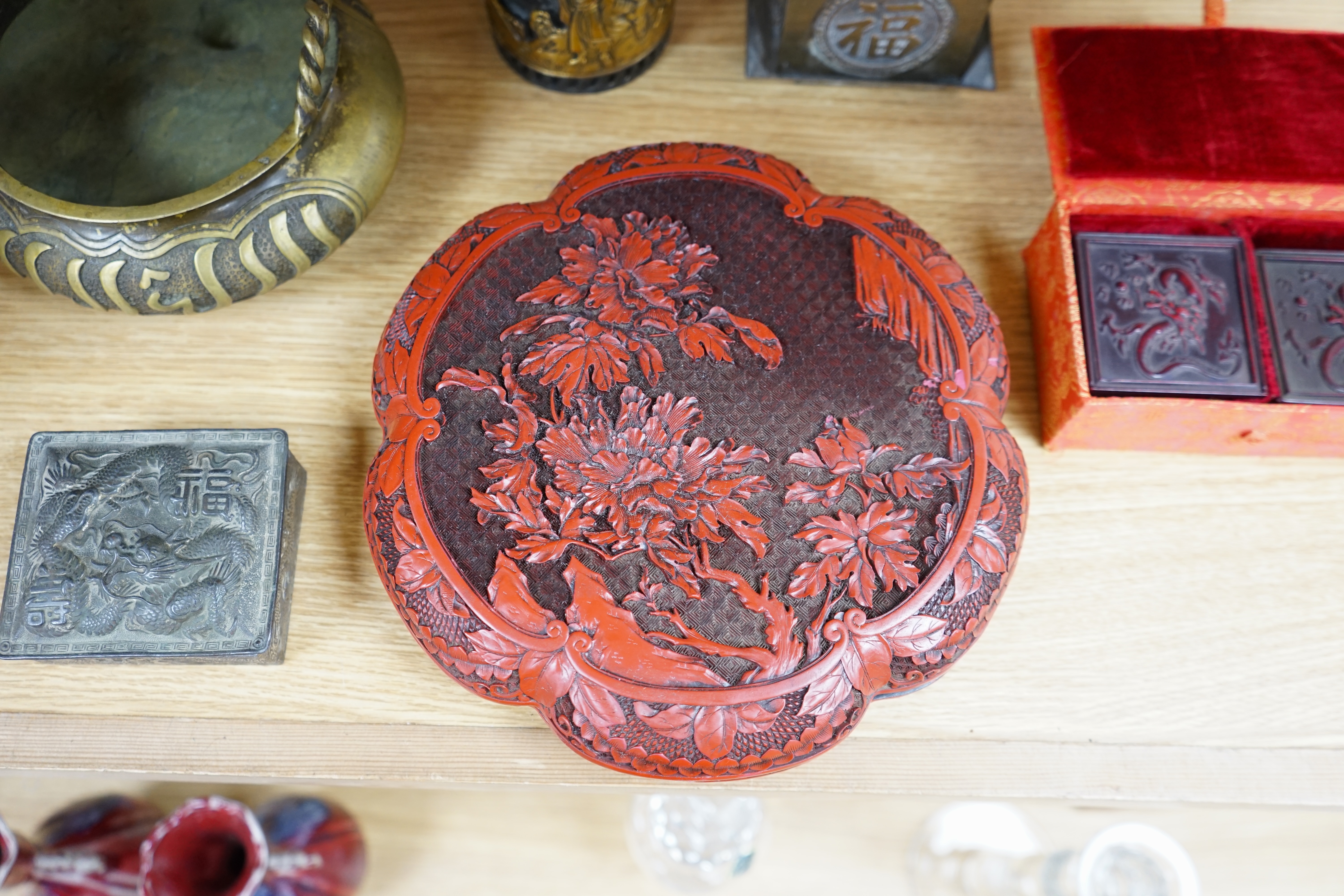 A collection of Chinese and Japanese items to include a lacquered box, a bronze tripod censer, a white metal box and carved seals, largest 25cm wide. Condition - mostly fair